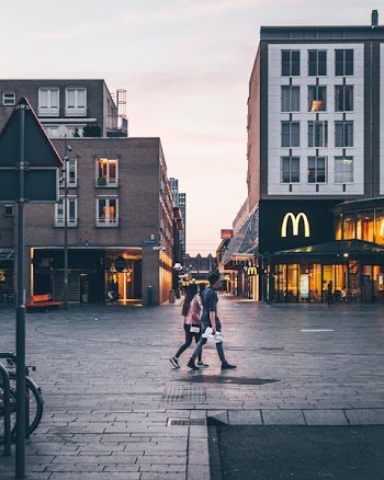 Man and Woman Walking on the Road