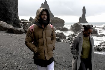 Man and Woman Wearing Jackets Walking on Shore