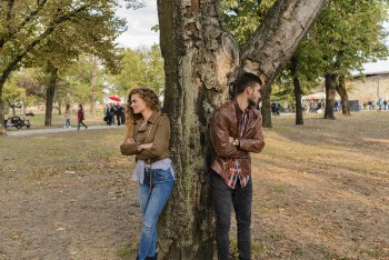 Man and Woman Wearing Leather Jackets Standing Under Tree
