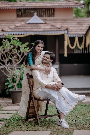 Man and Woman Wearing Traditional Clothing in Yard