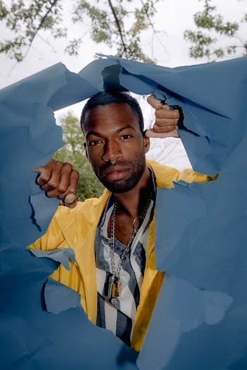 Man Behind A Ripped Blue Paper