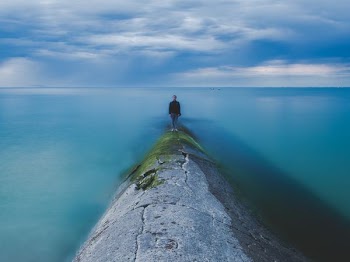 man beside body of water