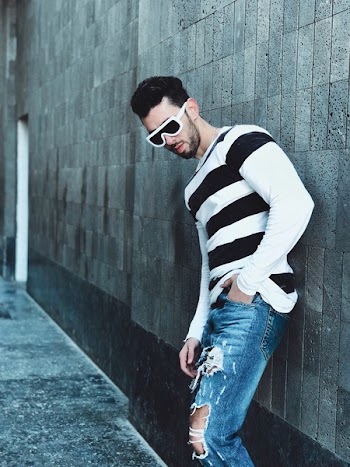 Man Beside Gray Wall