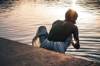 man beside the body of water