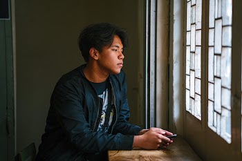 Man Beside Window Wearing Black Jacket