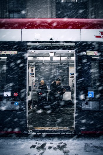Man Beside Woman in Train