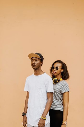 man beside woman wearing sunglasses