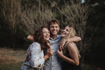 Man Between Two Women Smiling
