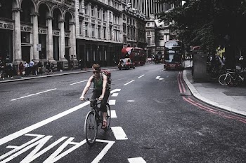 man bicycling at the road