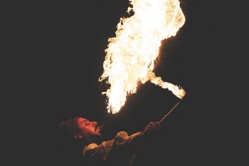Man Blowing Fire during Nighttime