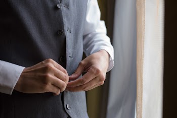 Man Buttoning His Shirt