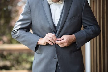 Man Buttoning His Suit Jacket
