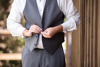 Man Buttoning His Vest