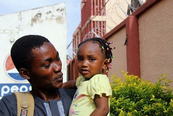 Man Carrying A Baby 