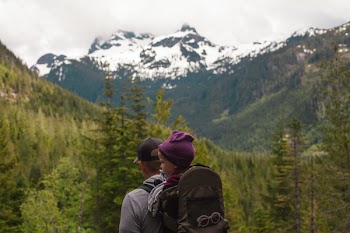 Man Carrying Baby With Brown Baby Carrier Near Trees