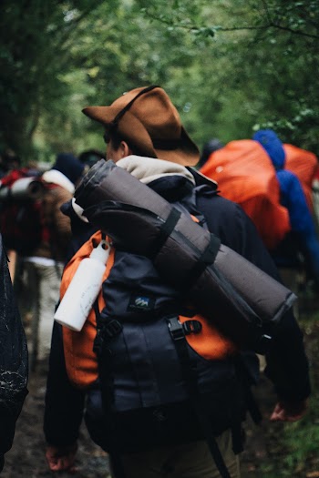 Man Carrying Bag and Blanket