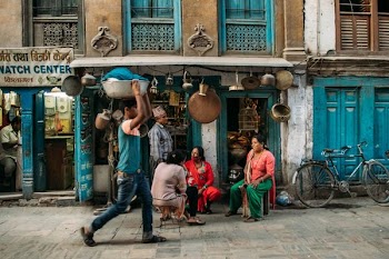 man carrying basin under his head
