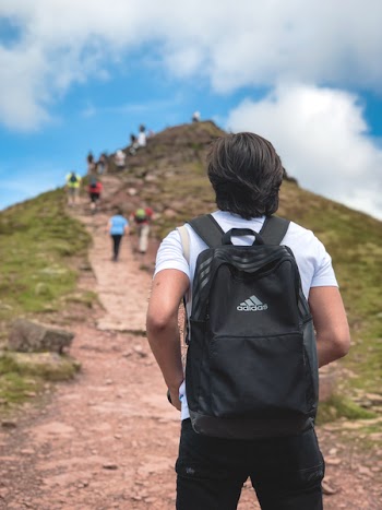 Man Carrying Black Addidas Backpack
