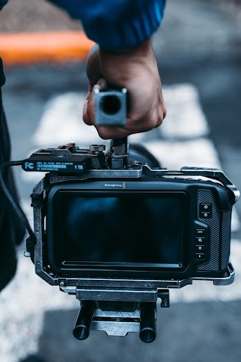 Man Carrying Black Video Camera