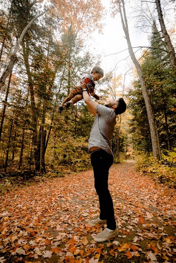 Man Carrying Boy Near Forest