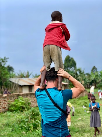 Man Carrying Boy On Shoulders