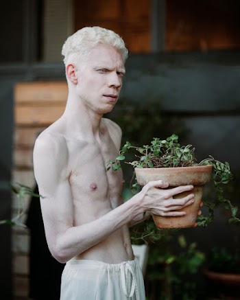 Man Carrying Brown Pot