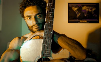 Man Carrying Brown Single Cutaway Guitar