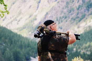 Man Carrying Camera With Tripod