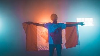 man carrying Canada flag