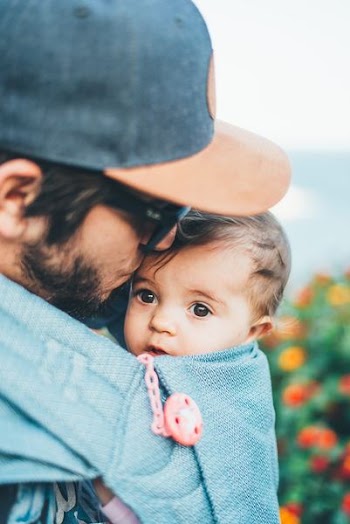 man carrying child on carrier