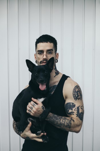 Man Carrying Dog