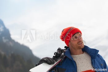 Man carrying skis
