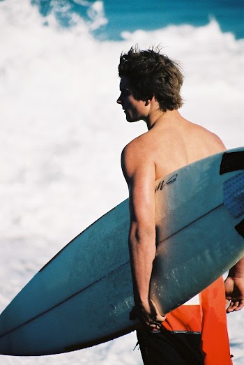 Man Carrying Surfboard