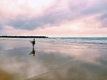 Man Carrying Surfboard