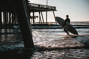 Man Carrying Surfboard