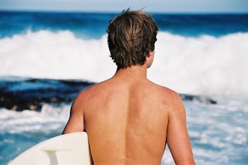 Man Carrying White Surfboard