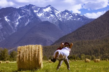 Man Carrying Woman In The Hay Field