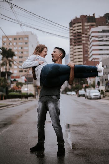 Man Carrying Woman in the Middle of Street