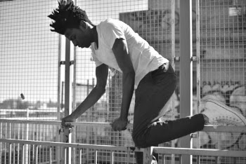 Man Climbing on Railings