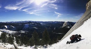 man climbing on snow