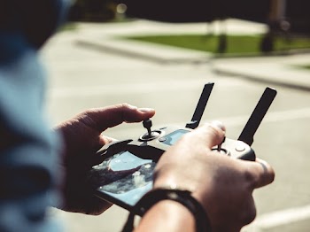 Man Controlling Drone With Remote