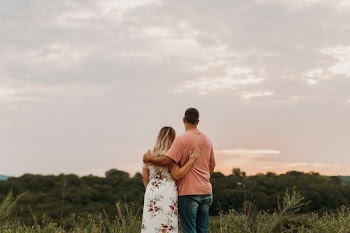 man couple hugging on green grass