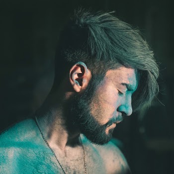 Man Covered in Colored Powder Looking down