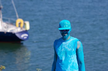 Man Covered With Blue Paint Near Body of Water