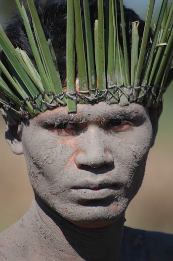 Man Covered With Mud and Wears Leaves Headpiece