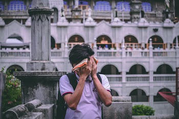 Man Covering Her Face With Towel