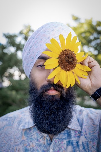 Man Covering His Eyes With Sunflower