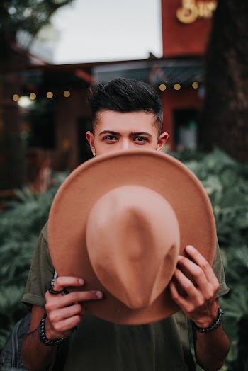 Man Covering His Face With Brown Wide Brim Fedora Hat