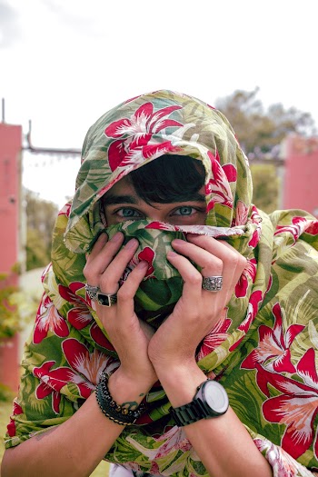 Man Covering His Face With Floral Blanket