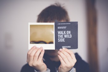 Man Covering His Face With Walk on the Wild Side Book
